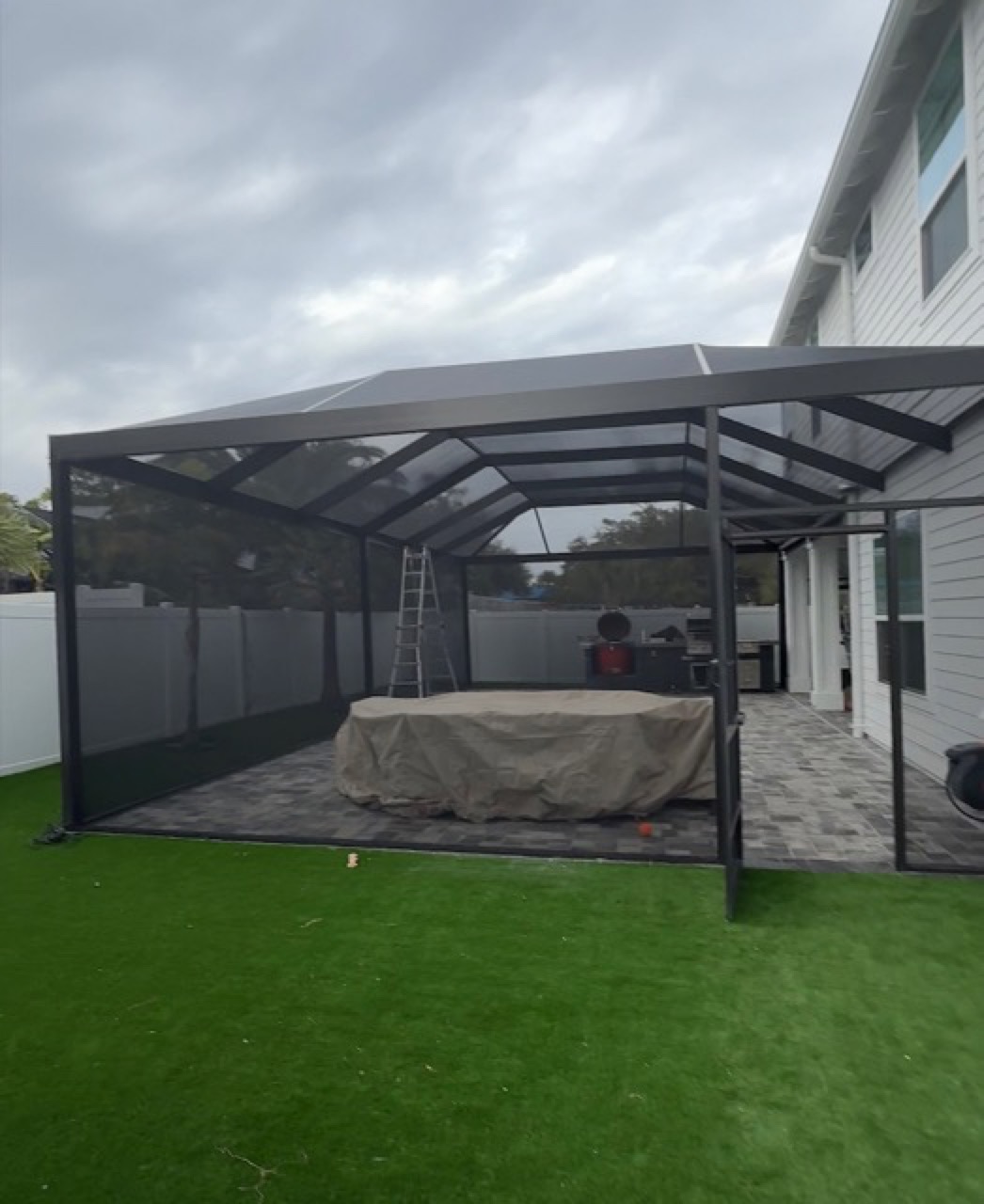 Screen enclosure around a pool