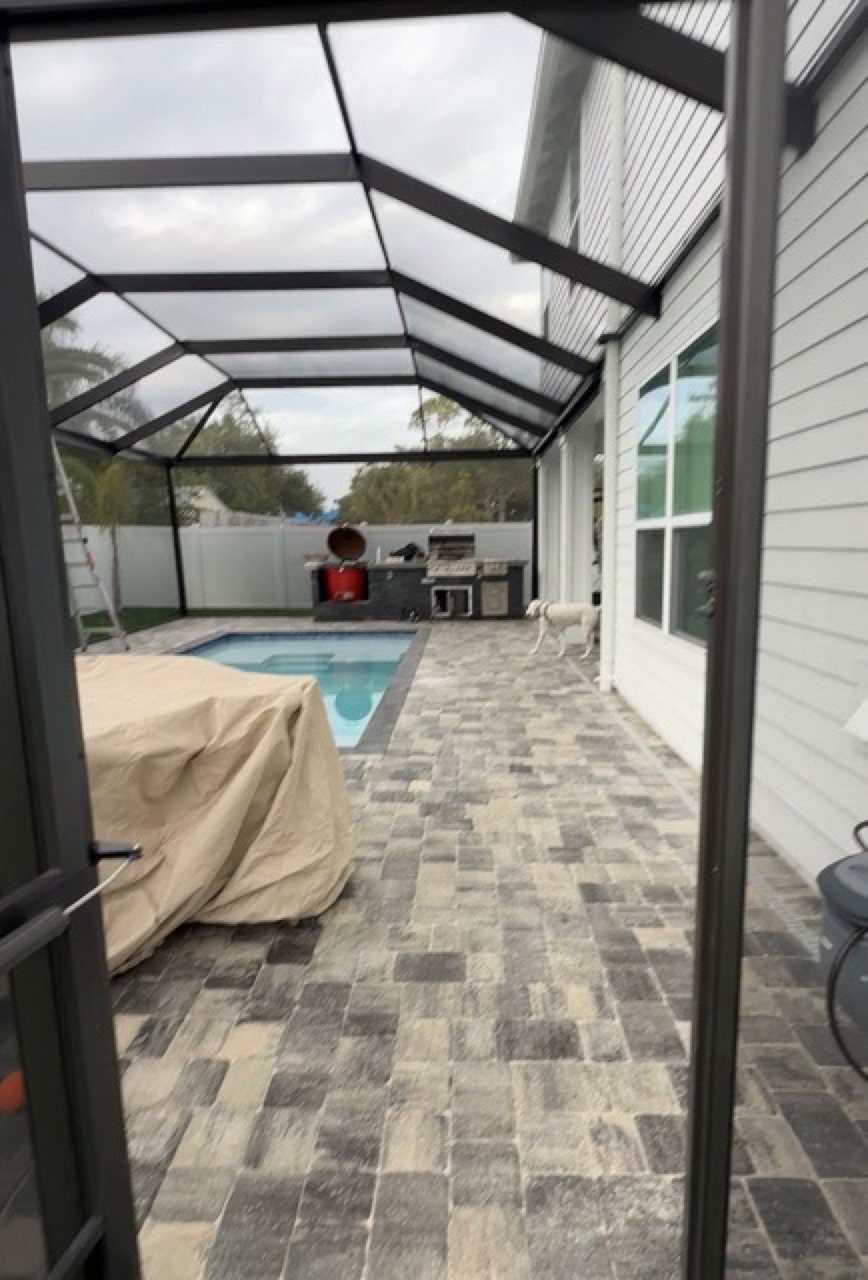 View across a screened pool deck toward the pool